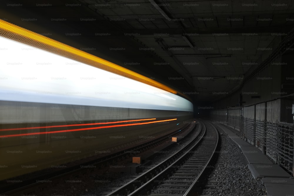 a blurry photo of a train going through a tunnel