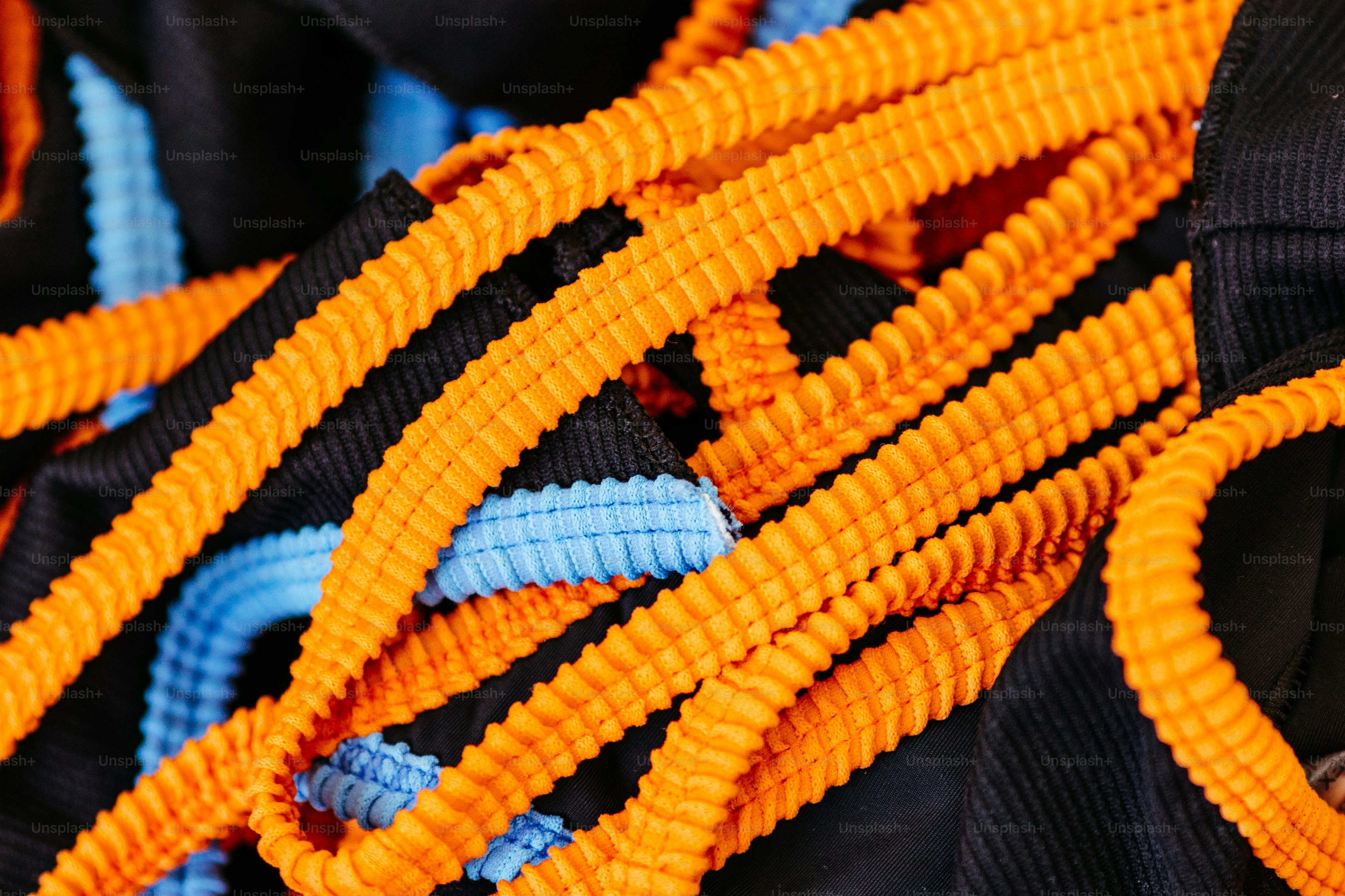 A close up of a bunch of orange and blue ropes photo – Orange and blue ...