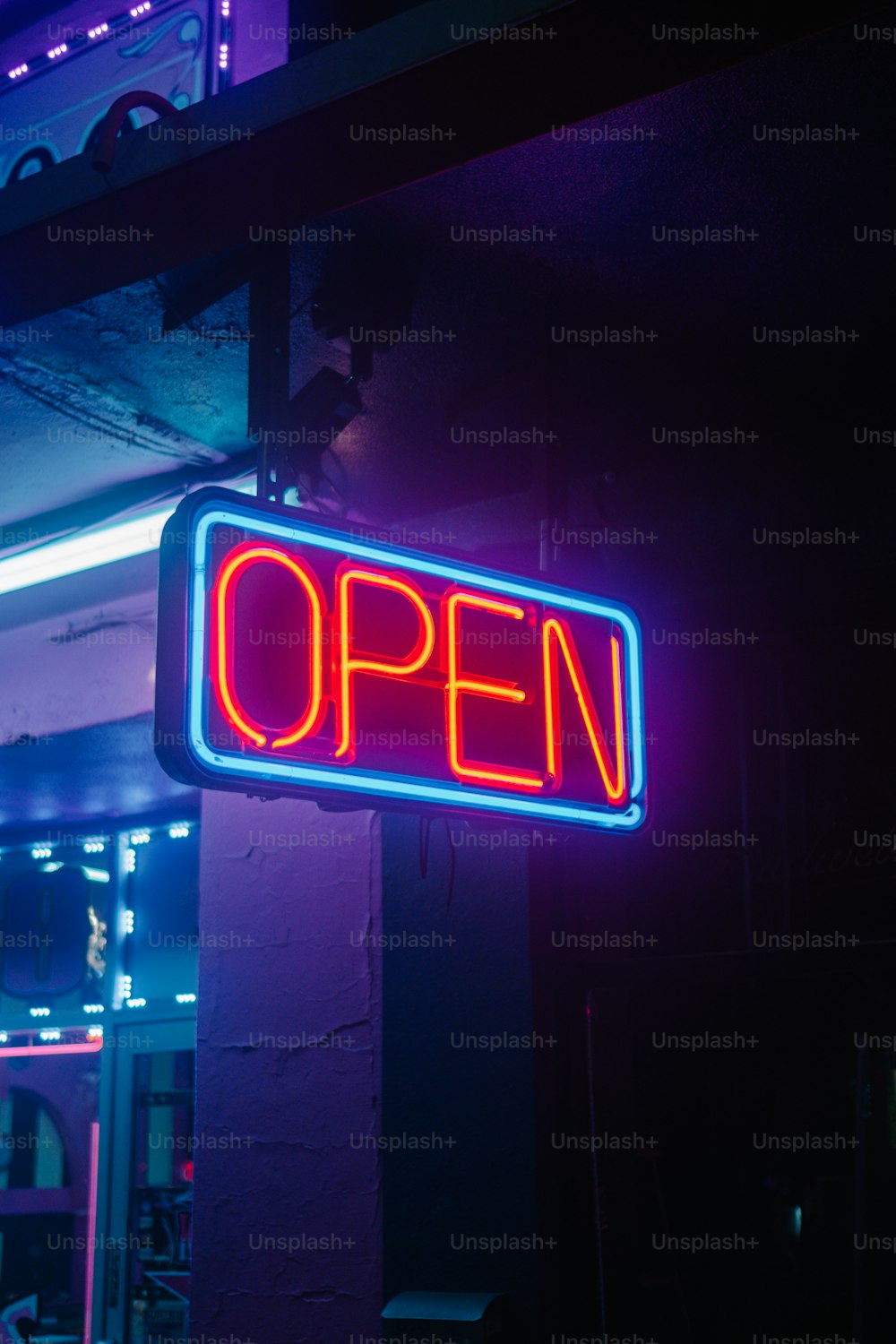 a neon sign that says open on a building