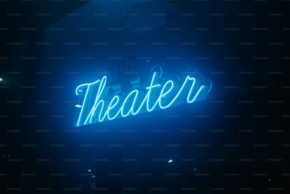 a theater sign lit up in the dark