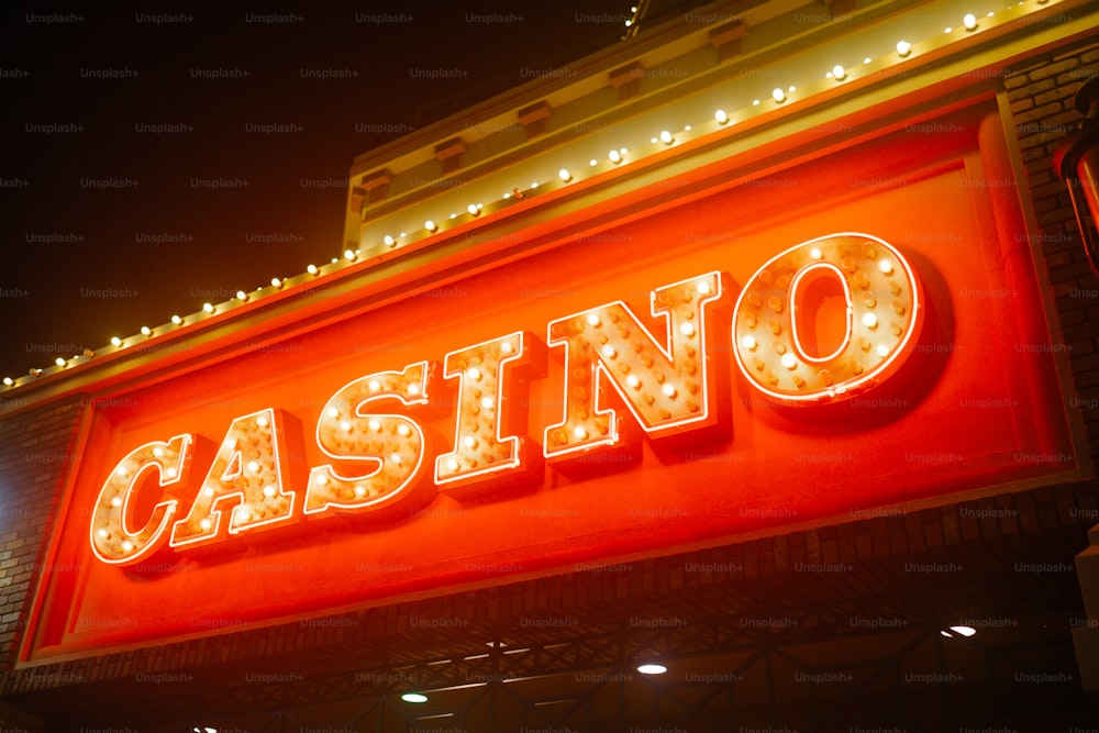 a casino sign lit up at night with lights