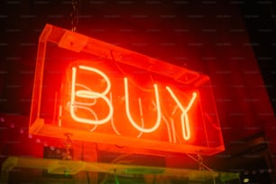 a neon sign that says buy on it
