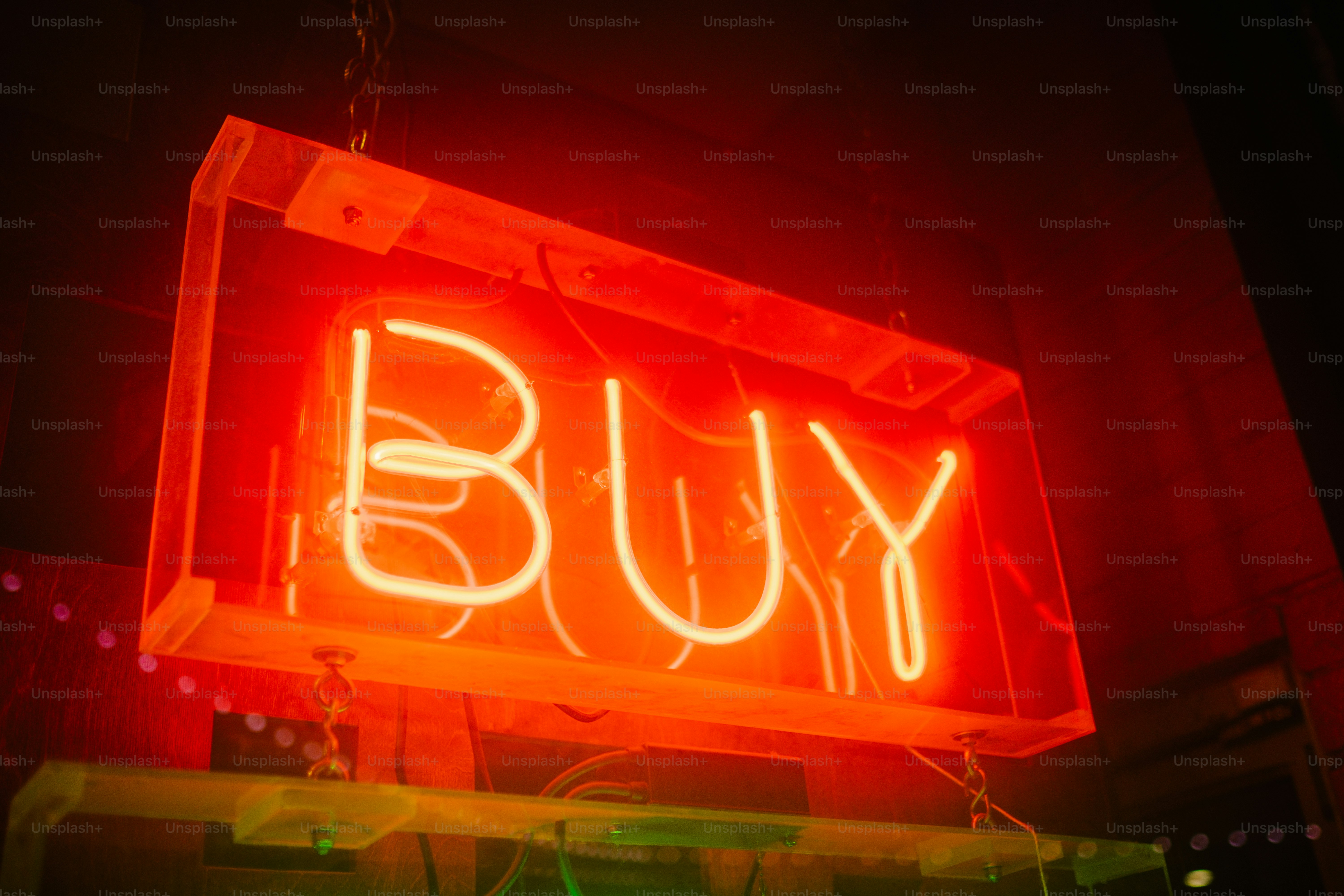 a neon sign that says buy on it