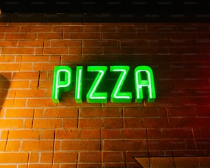 a neon sign that reads pizza on a brick wall