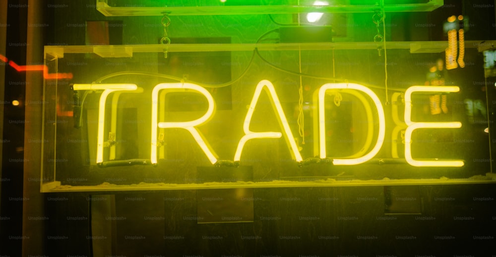 a neon sign that reads trade on it