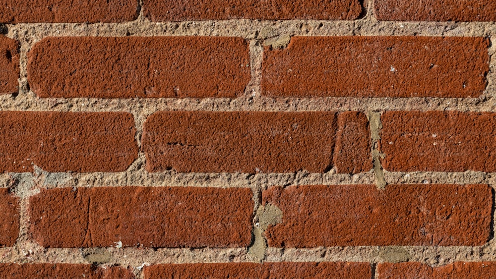 a close up of a brick wall made of red bricks