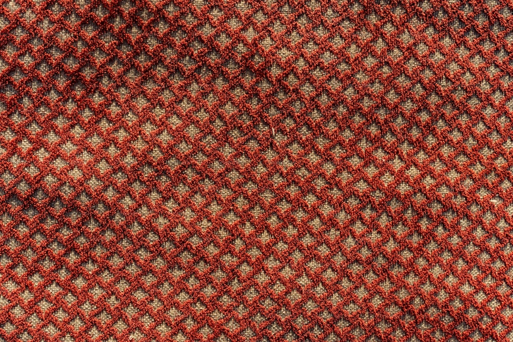 a close up of a red and black checkered tie