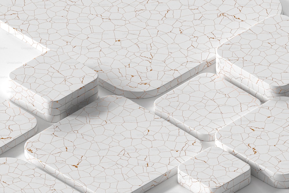 a group of white and gold tiles on a white surface