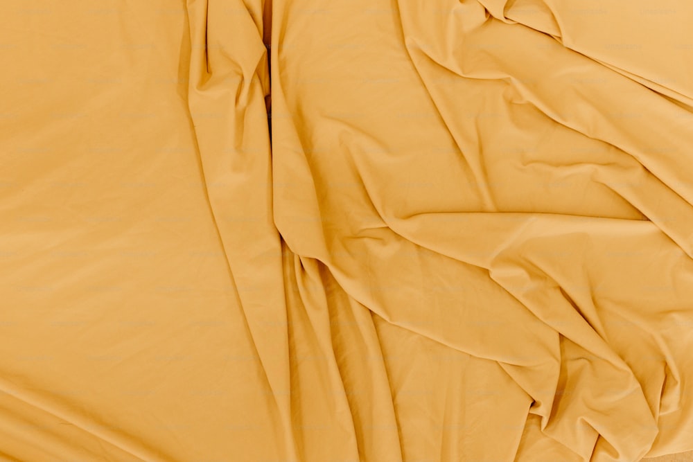 gros plan d’un lit avec des draps jaunes