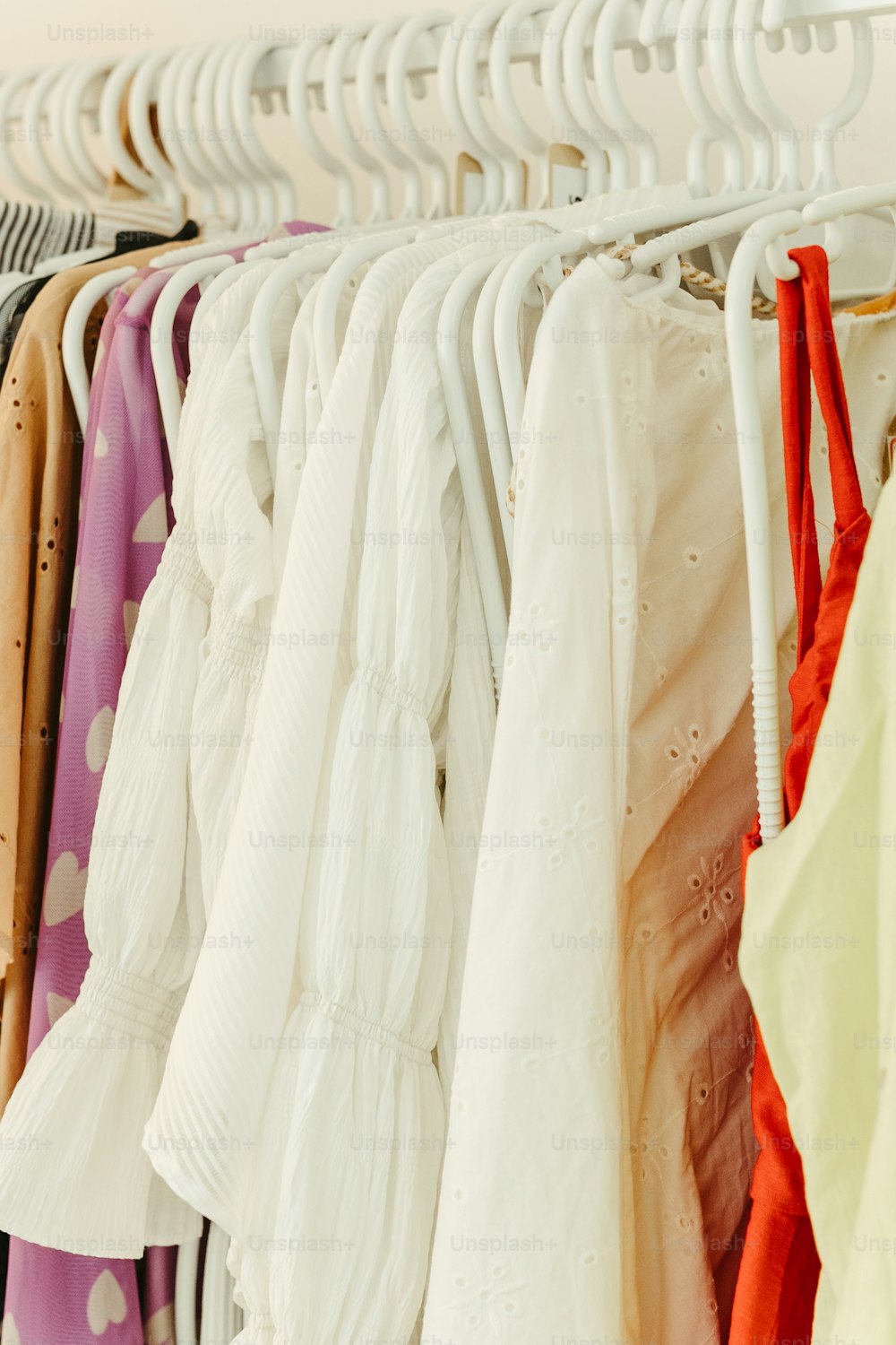 a rack of clothes hanging on a rail