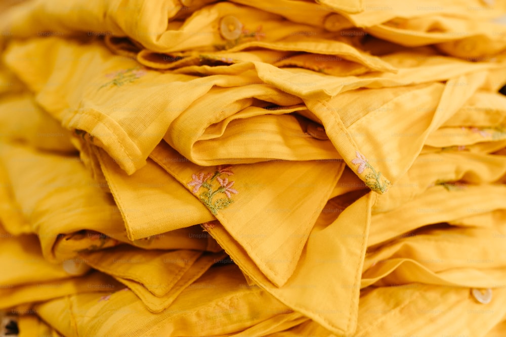 a pile of yellow cloths sitting on top of each other