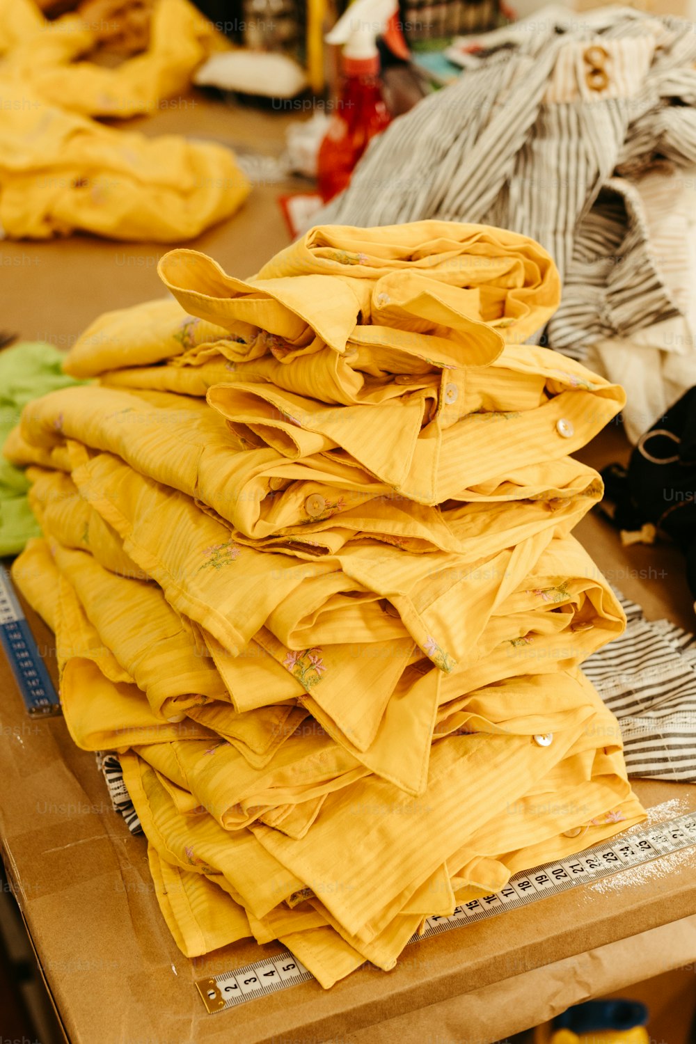 a pile of yellow cloth sitting on top of a wooden table