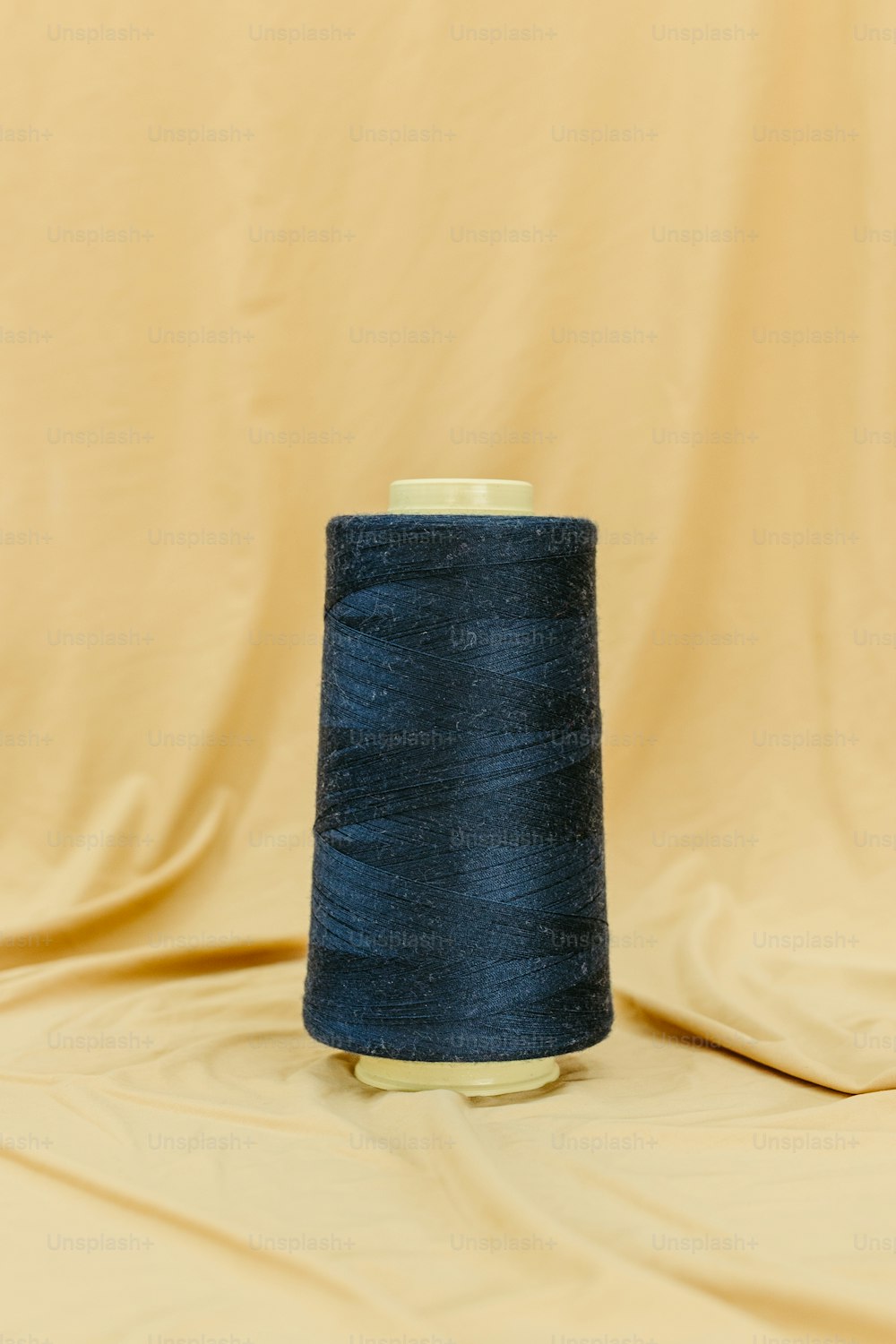 a spool of blue thread sitting on top of a table