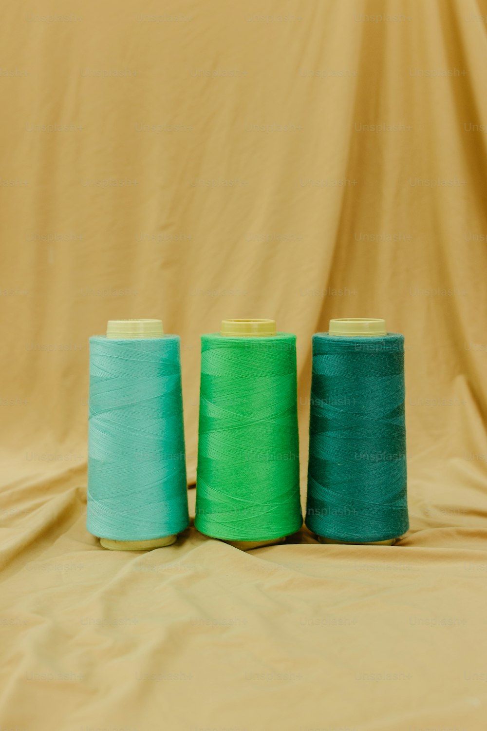 three spools of thread sitting on top of a table