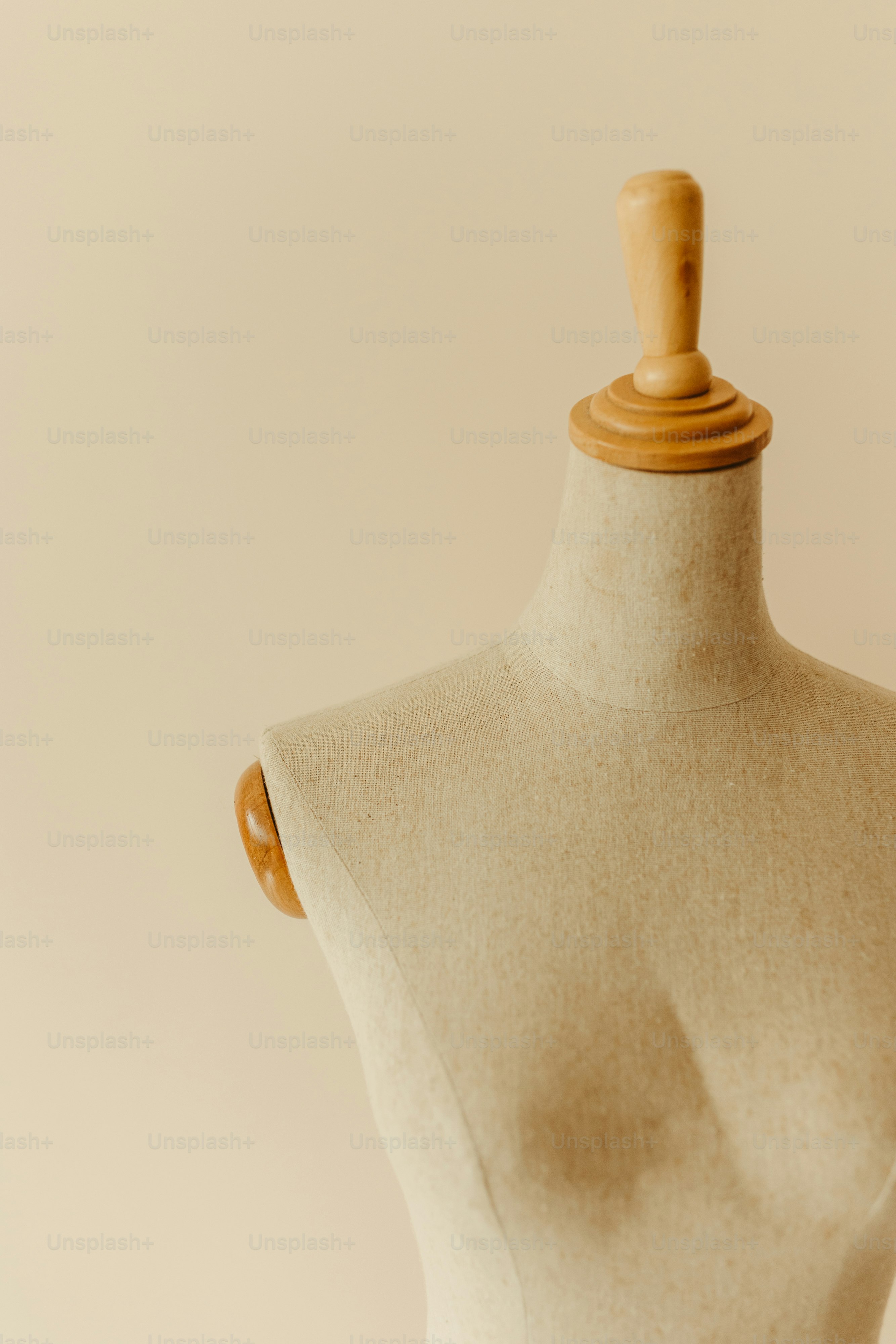 a white mannequin with a wooden top