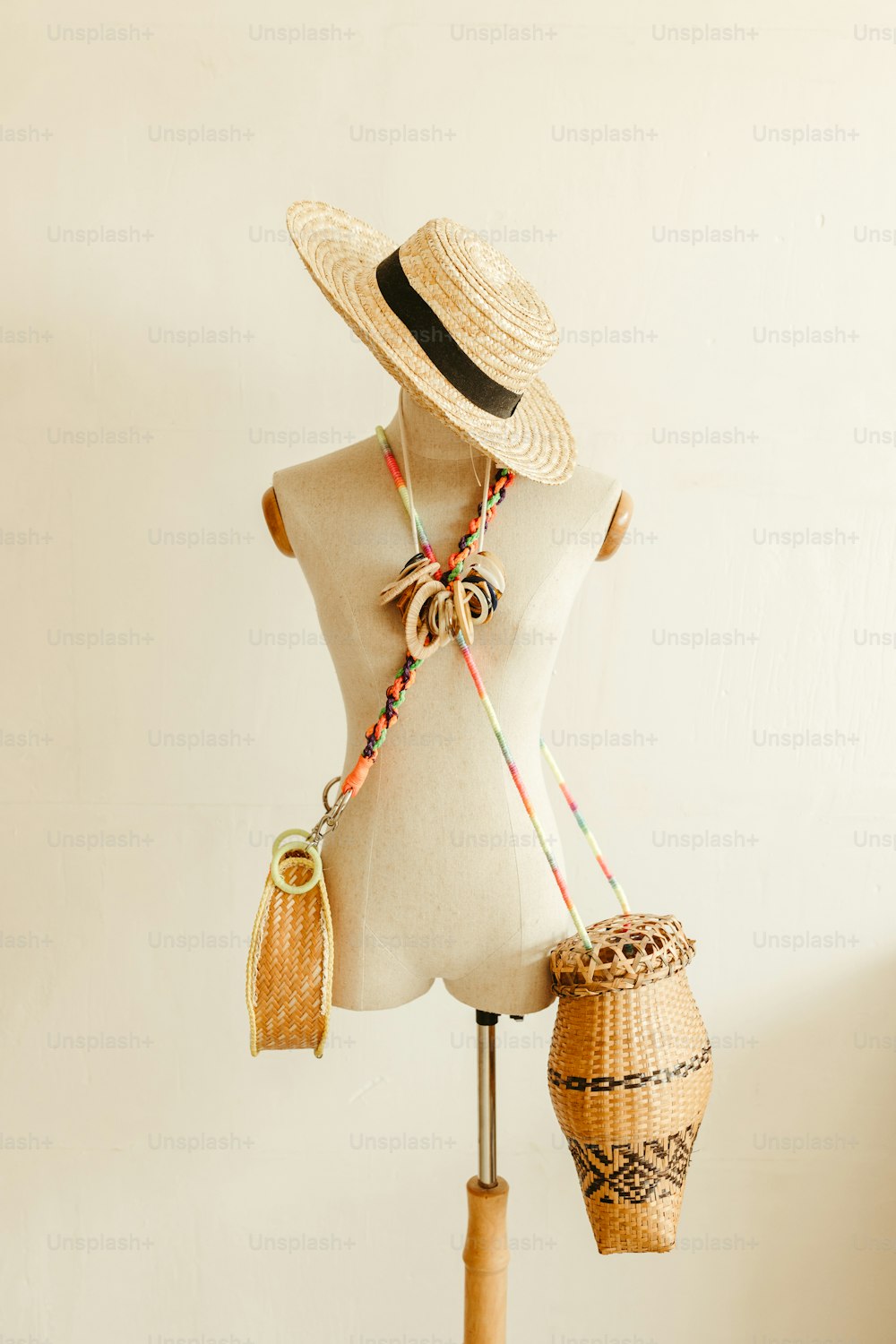 a mannequin wearing a straw hat and carrying a basket