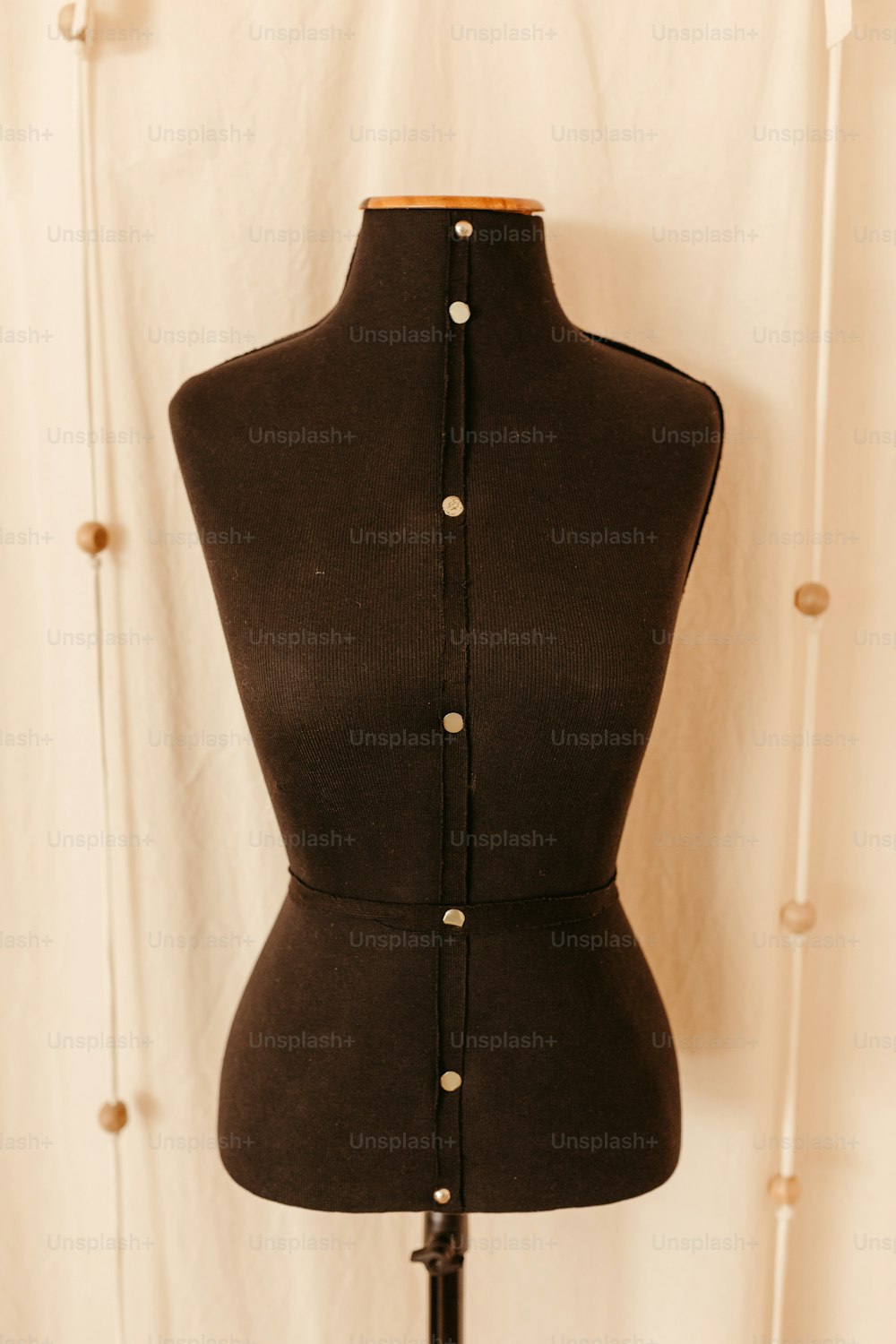 a black mannequin with buttons on it
