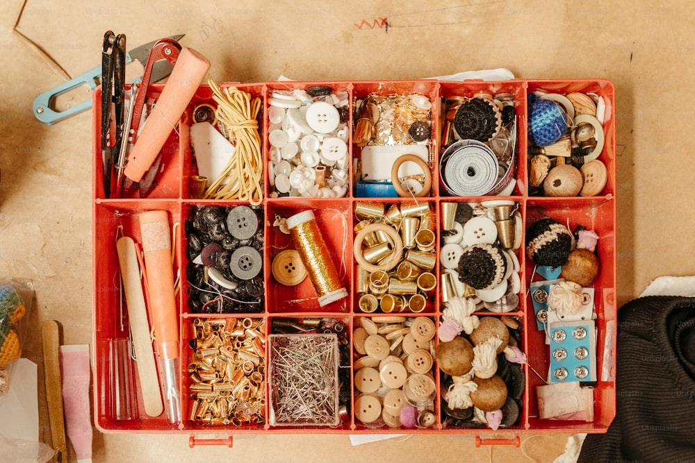 a red box filled with lots of different types of buttons