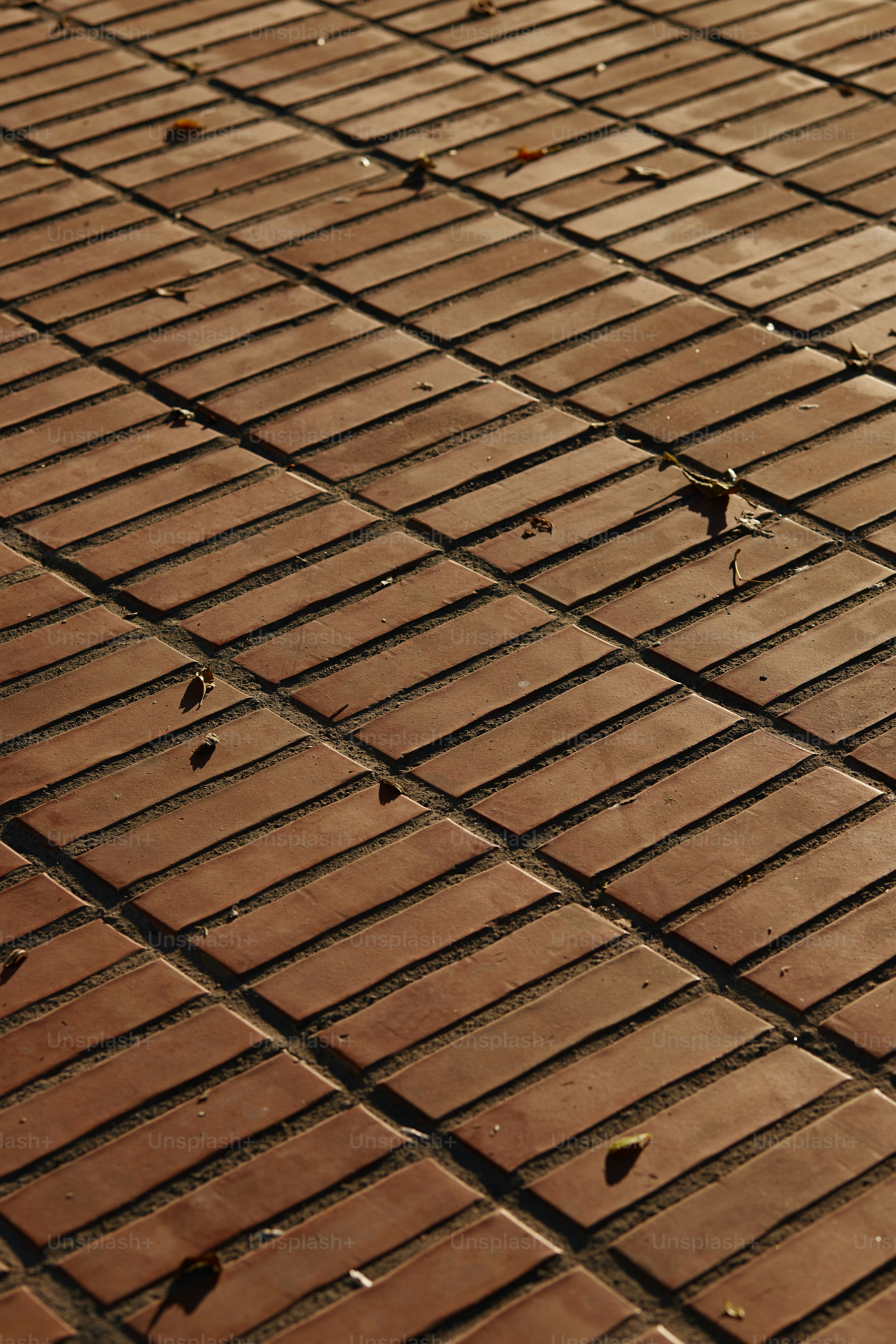 a red stop sign sitting on the side of a brick road