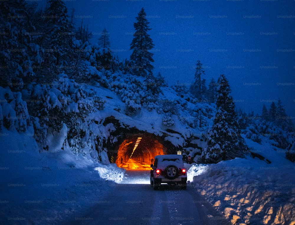 a car driving through a tunnel in the snow