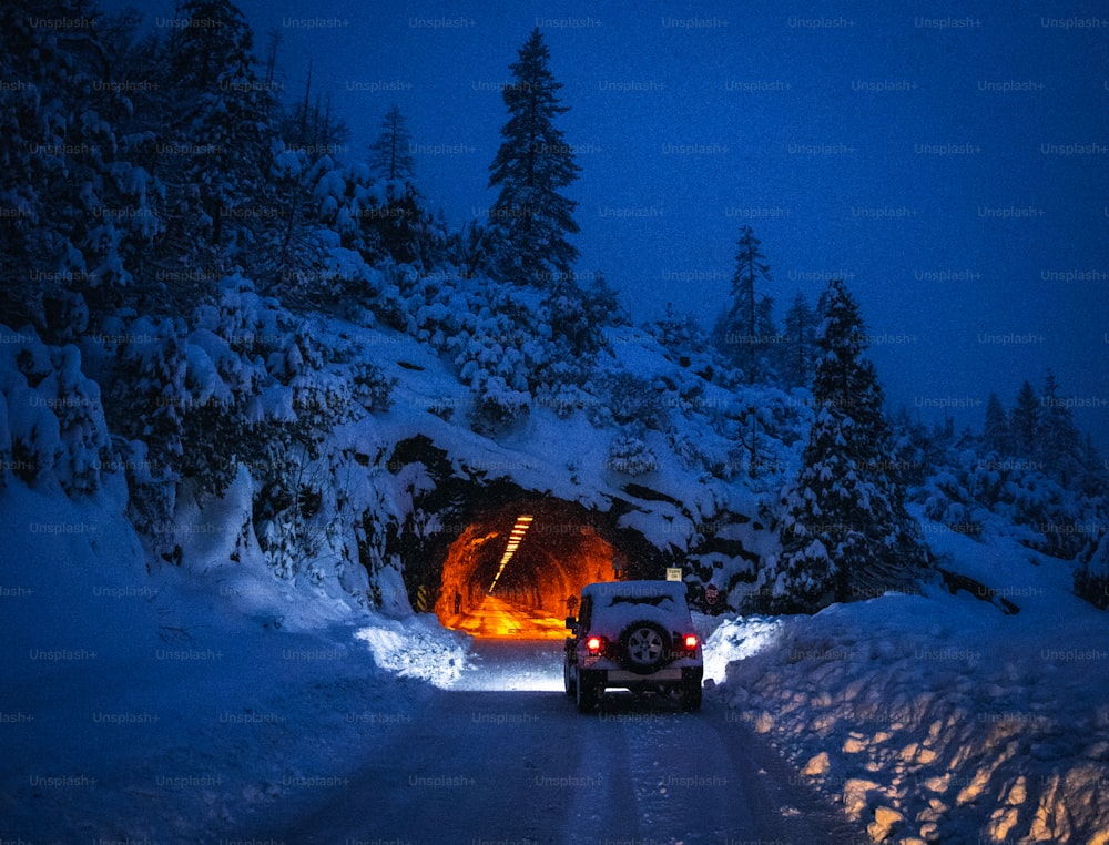 a car driving through a tunnel in the snow