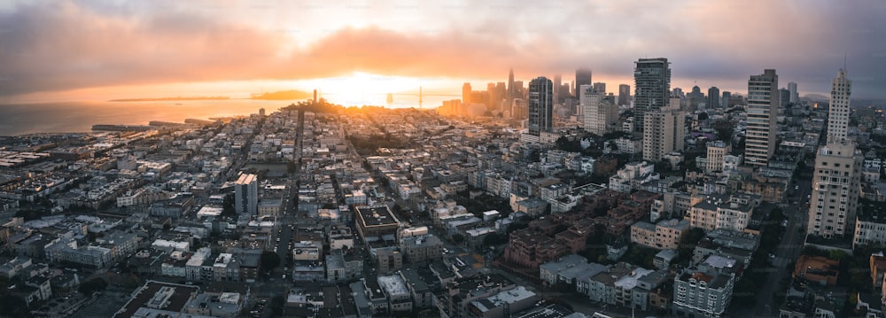 an aerial view of a city at sunset