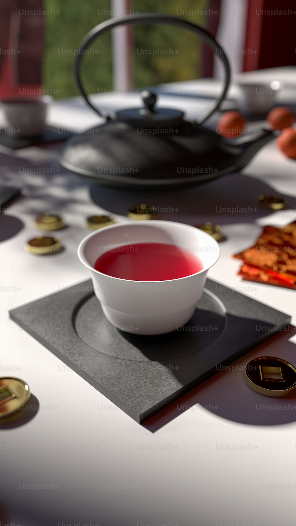a bowl of red liquid sitting on top of a white table