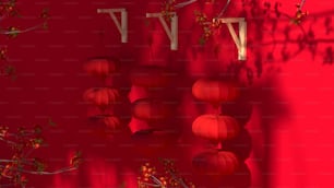 a red wall with chinese lanterns hanging from it