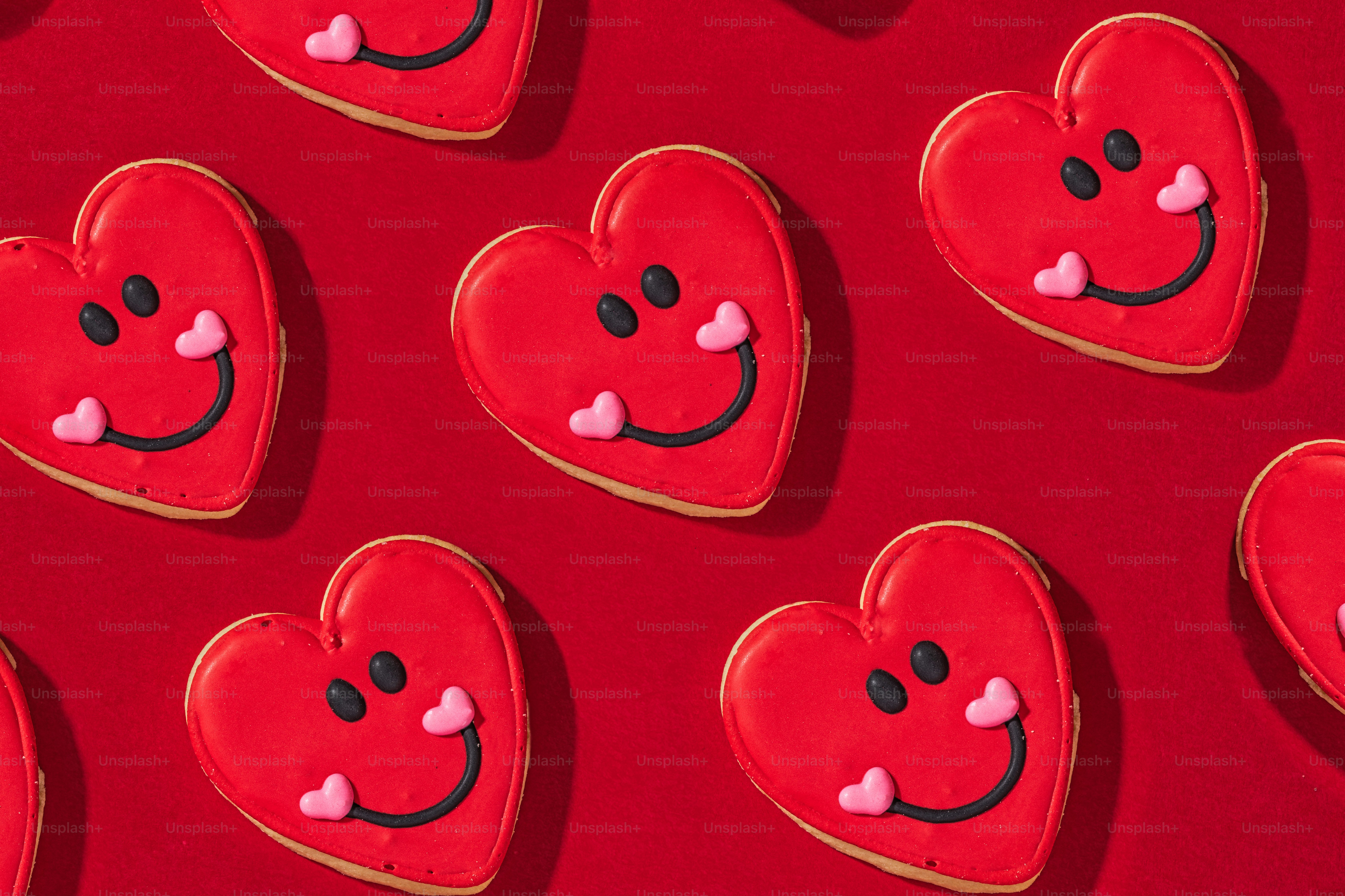heart shaped cookies arranged on a red surface