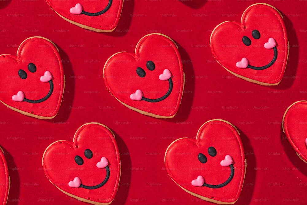 heart shaped cookies arranged on a red surface