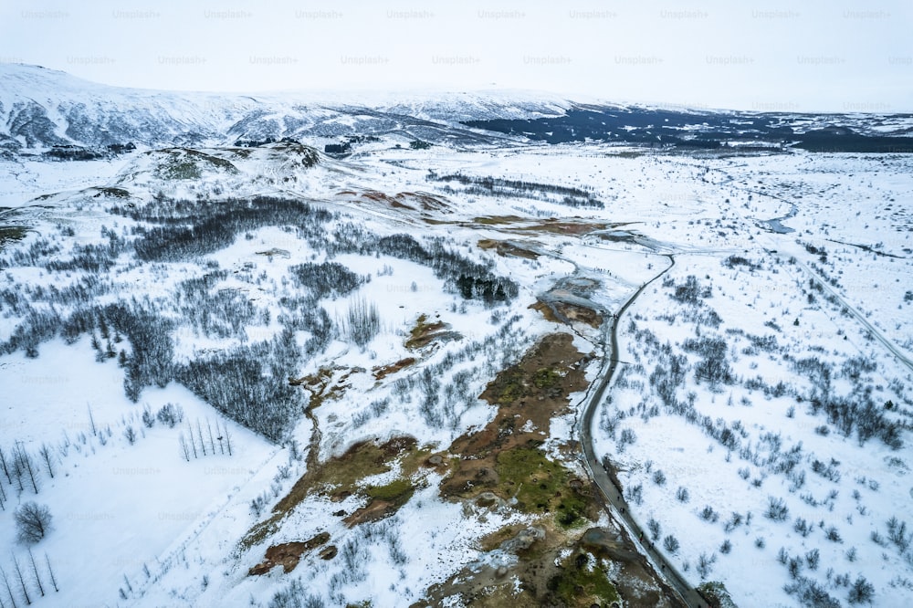 an aerial view of a snow covered landscape