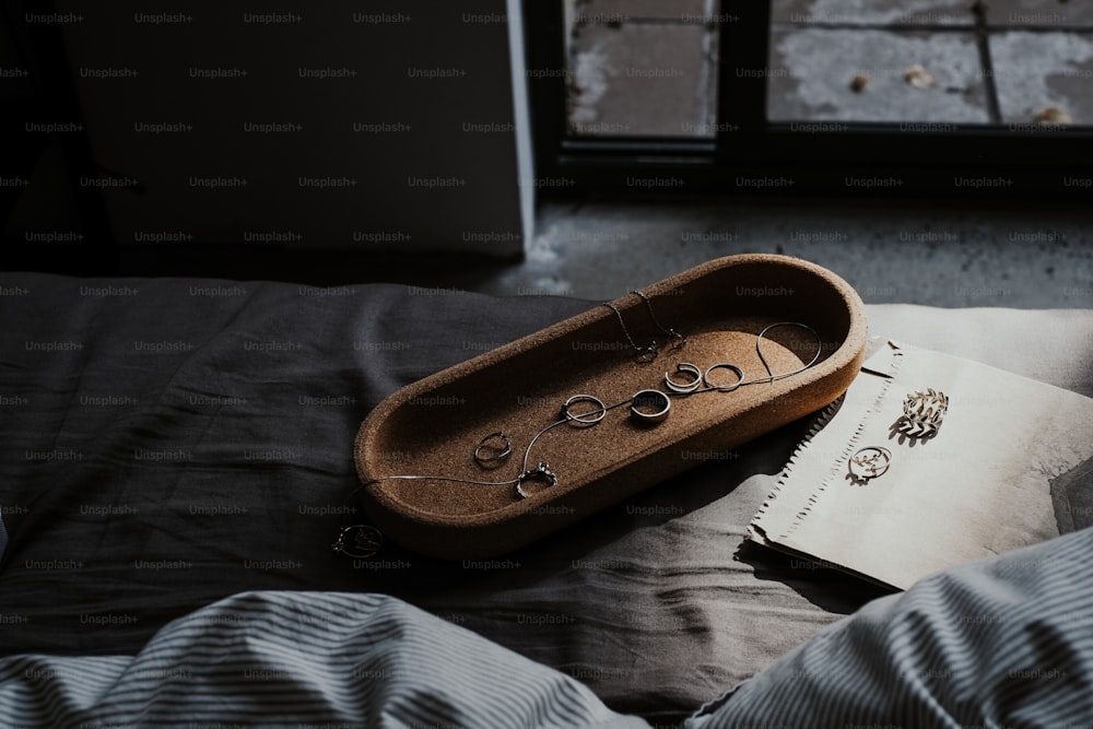 a book and a pair of eyeglasses on a bed