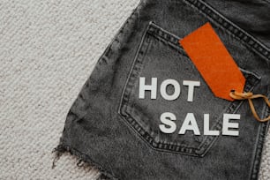 a pair of jeans with a hot sale tag on it