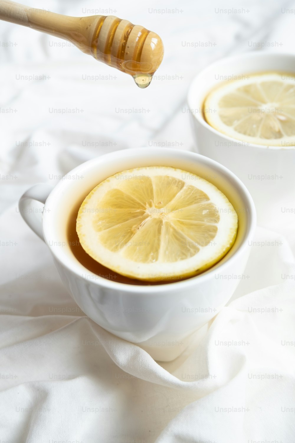 a cup of tea with a lemon slice in it