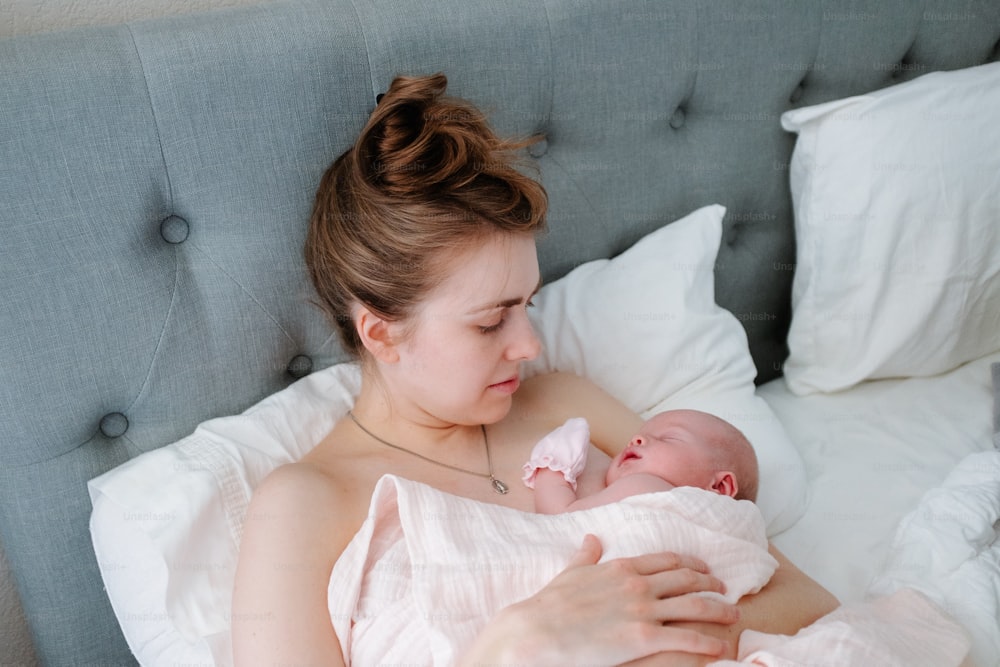 a woman holding a baby in her arms