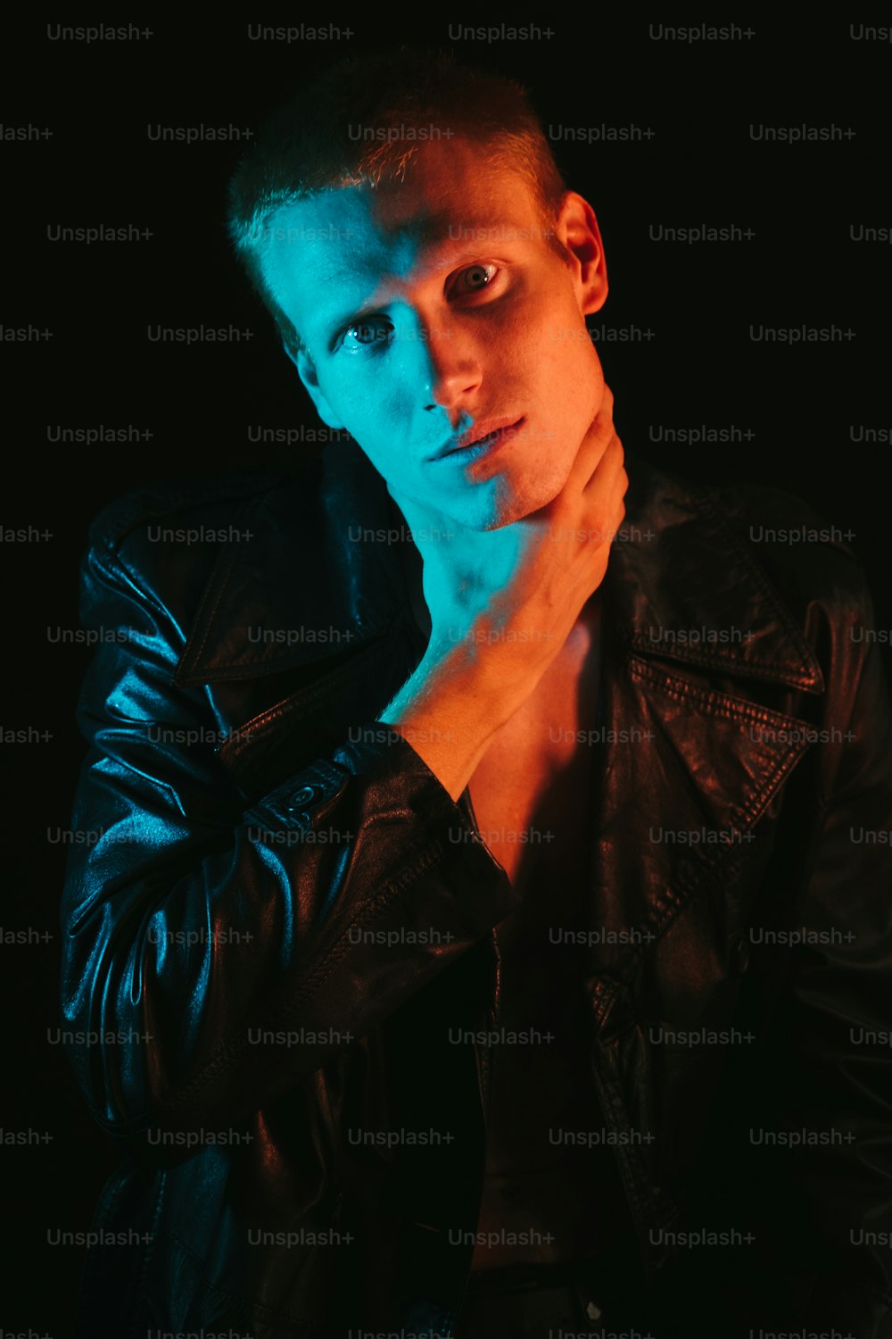 a man in a leather jacket posing for a picture