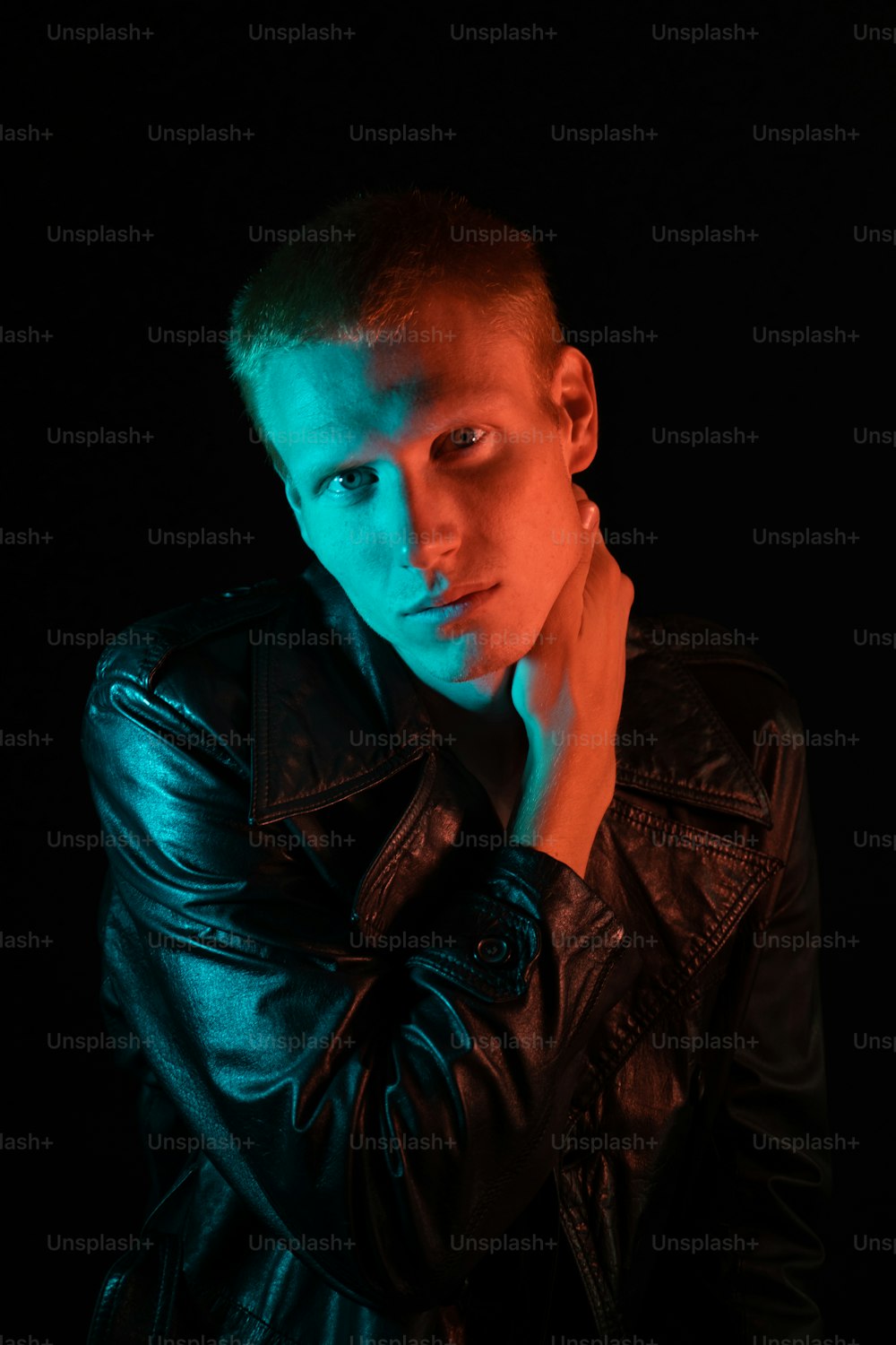 a man in a leather jacket posing for a picture