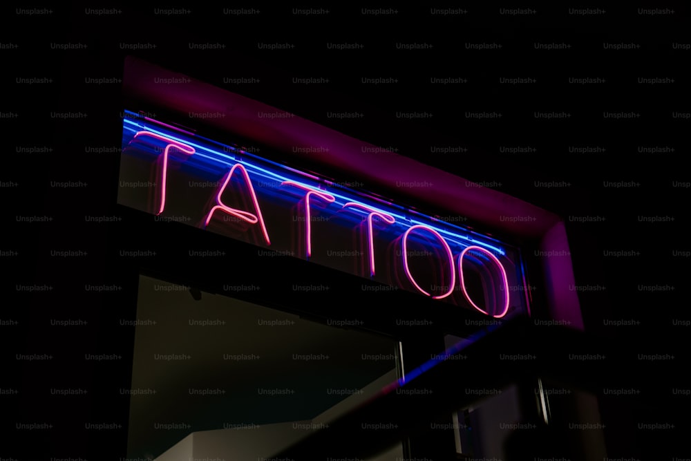 a neon sign that says tattoo on it