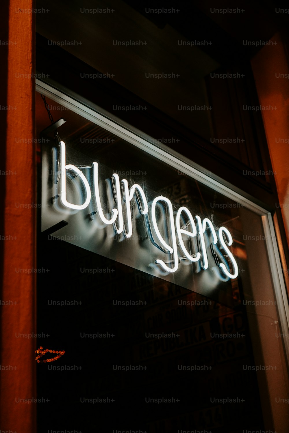 a neon sign is lit up in the window of a restaurant