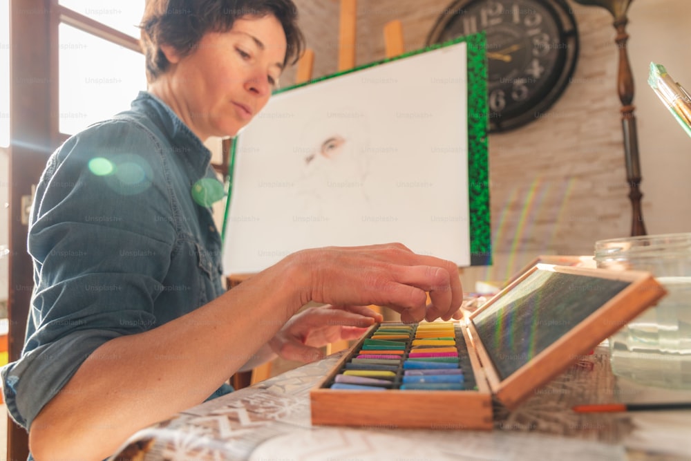Una donna che lavora a un progetto artistico con matite colorate