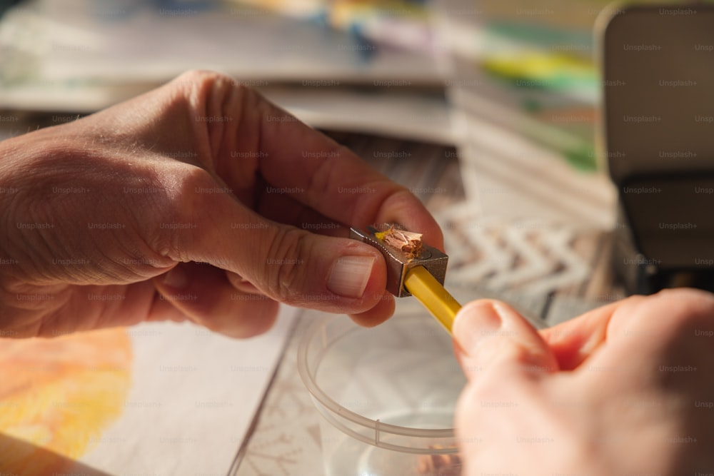 a close up of a person cutting a piece of paper