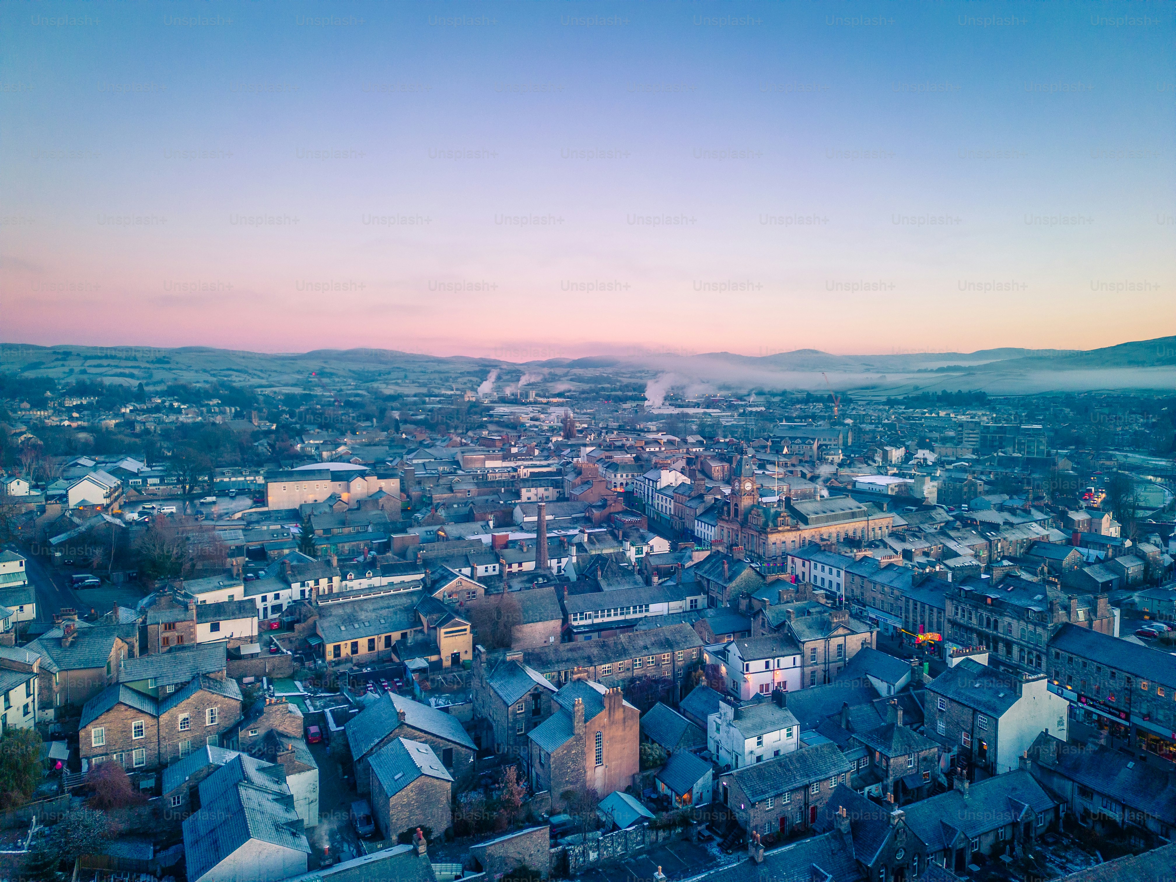 an aerial view of a city with mountains in the background