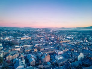 an aerial view of a city with mountains in the background