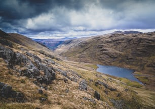 a view of a valley with a body of water in the distance