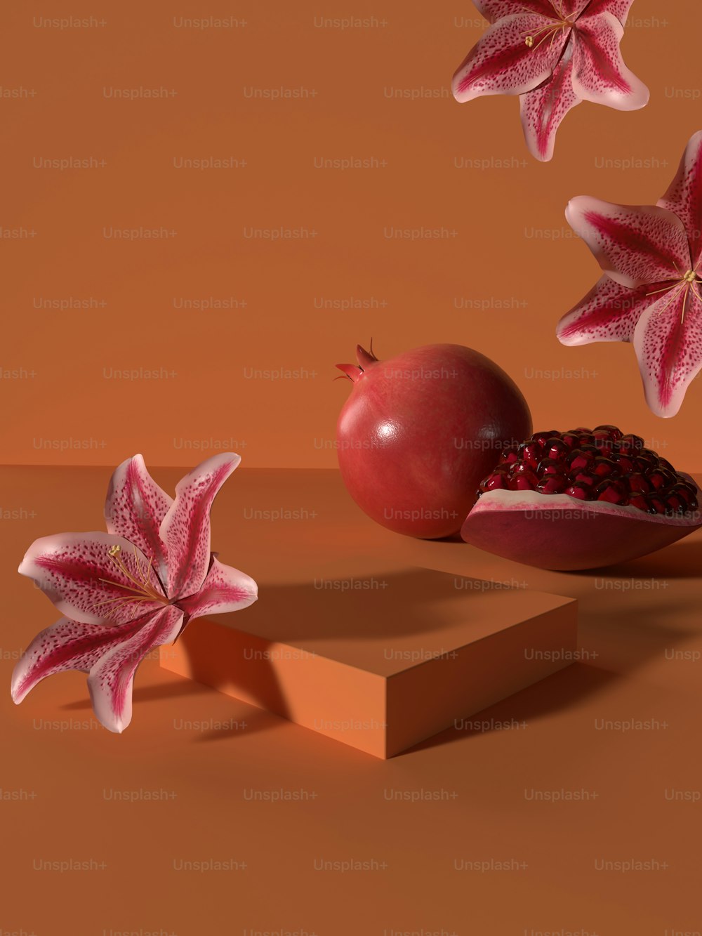uma romã e dois pedaços de fruta em uma mesa