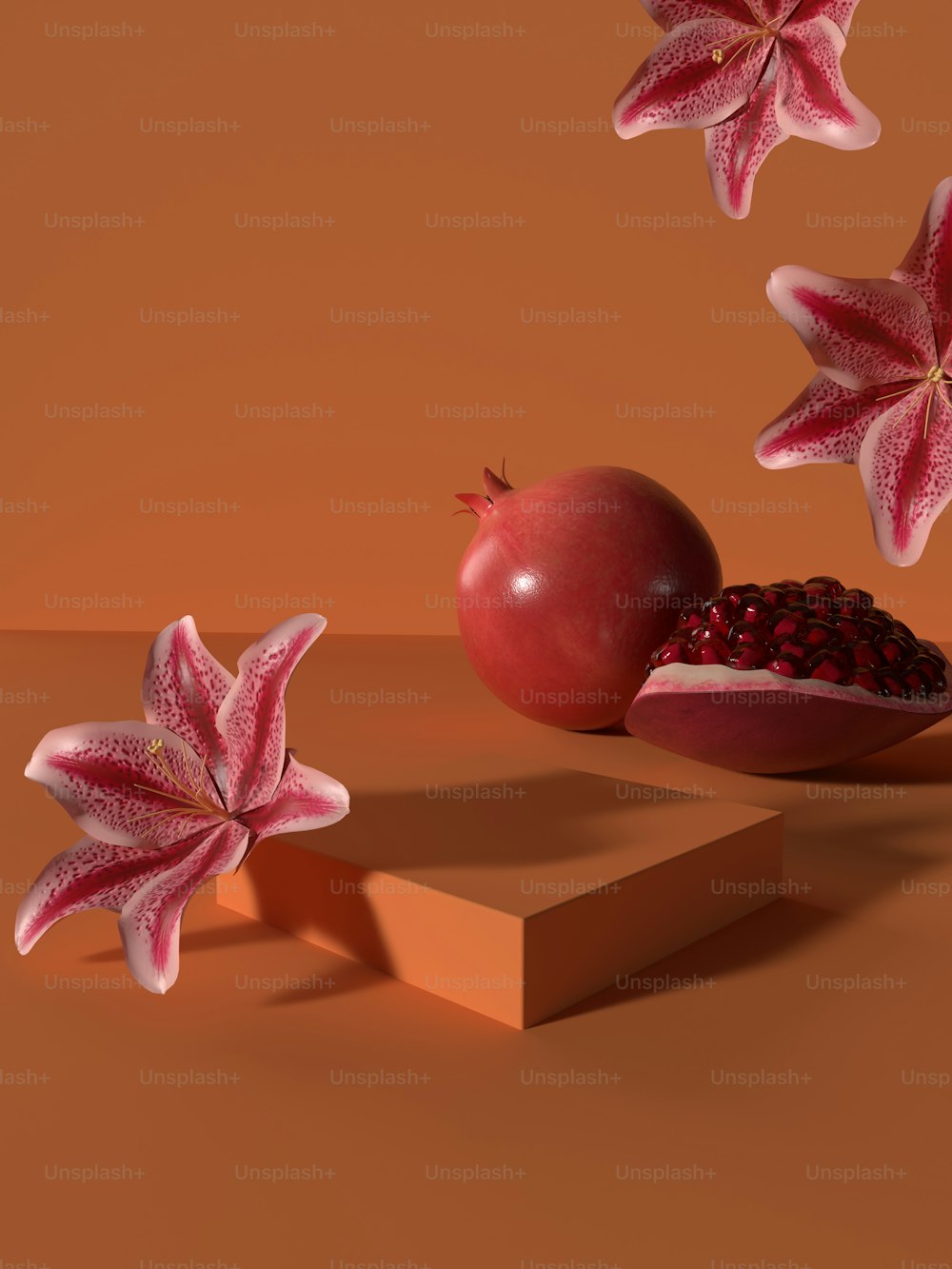 a pomegranate and two pieces of fruit on a table