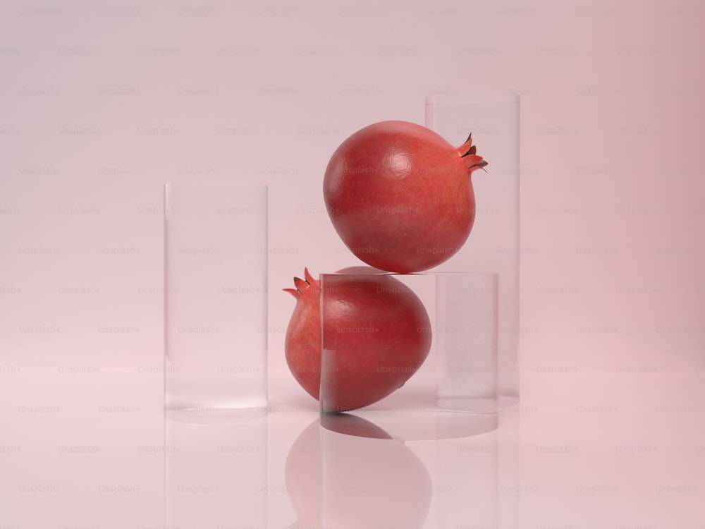 two pomegranates sitting in a glass vase