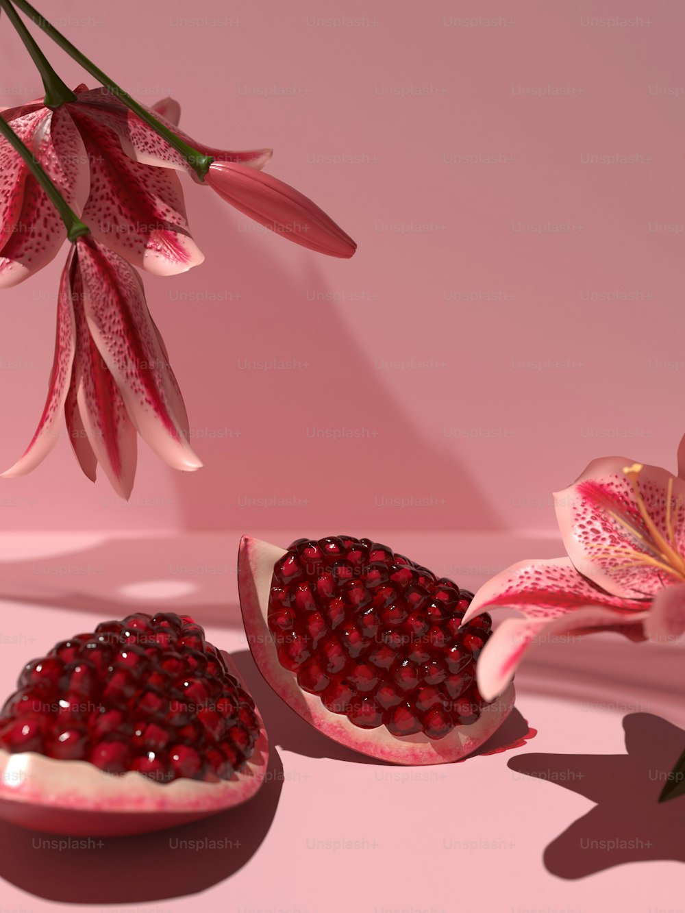 a pomegranate and a flower on a pink background