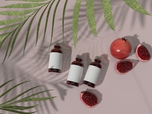 three bottles of pomegranate sit next to a half - ripe pome