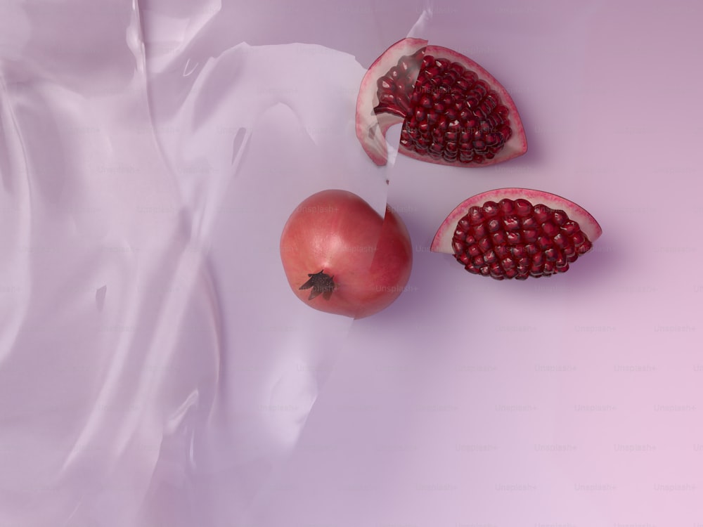 two pomegranates and a half of a pomegranate on